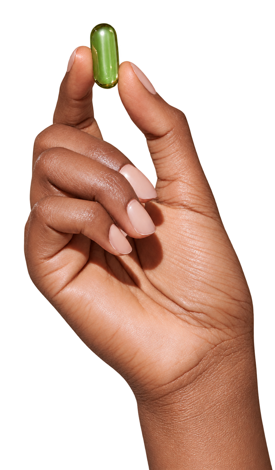 Hand holding a green medication capsule